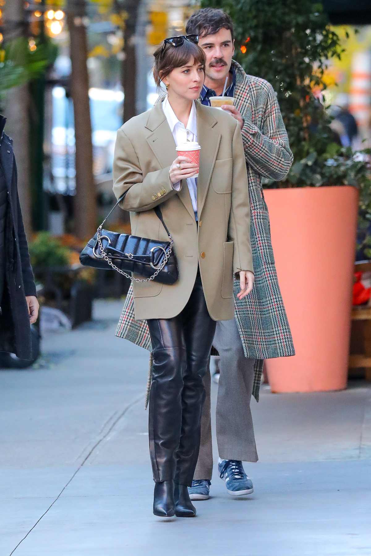 Dakota Johnson Wearing Gucci And Carrying A Gucci Horsebit Chain Shoulder Bag